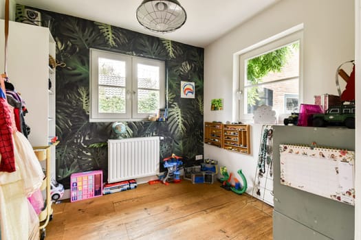 A vibrant children's room featuring lush tropical wallpaper, playful decor, and wooden flooring, creating a welcoming and fun space for kids.