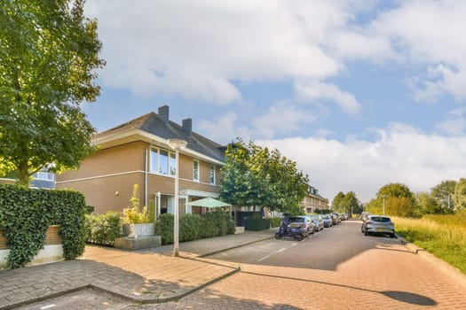 A picturesque residential street featuring charming houses, lush greenery, and a tranquil atmosphere, perfect for a peaceful community setting.