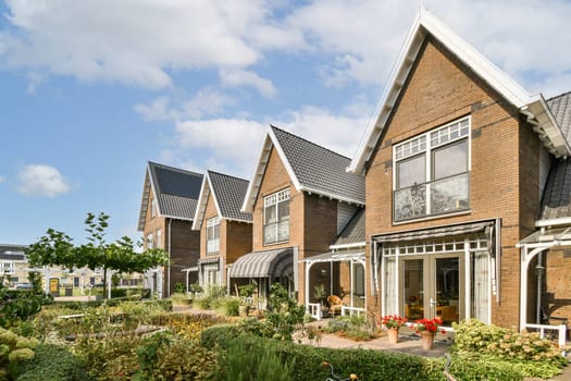 Showcasing contemporary houses surrounded by vibrant gardens, blending natural beauty with architectural elegance in a tranquil neighborhood setting.