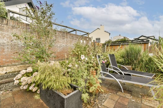 A beautifully arranged garden showcasing vibrant plants and flowers with stylish modern seating, perfect for relaxation and outdoor living.