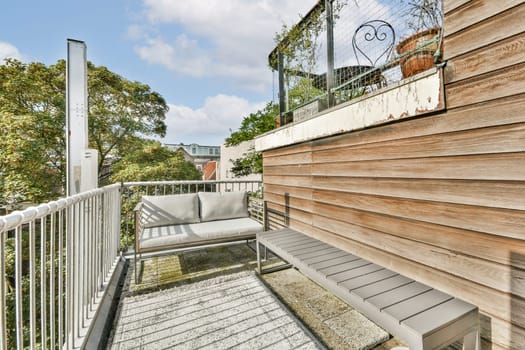 A stylish outdoor balcony featuring contemporary seating, surrounded by greenery, ideal for relaxation and enjoying fresh air. Perfect for urban living spaces.
