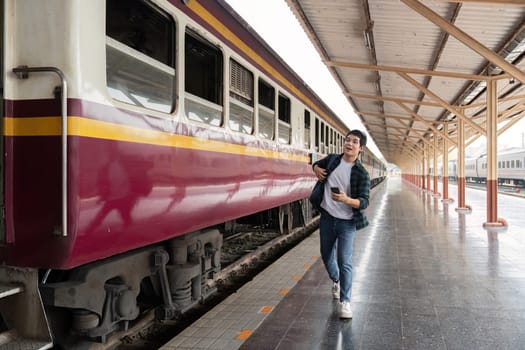 With a confident stride, a traveler walks alongside the train, embodying the essence of exploration and anticipation for what's next.