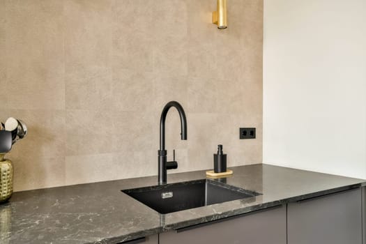 The image features a sleek modern kitchen sink with a black faucet and elegant marble countertop, presenting a contemporary aesthetic in interior design.