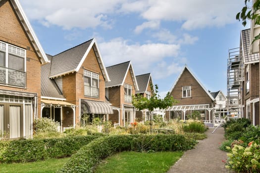 Beautiful suburban houses lined with greenery and landscaped gardens, offering a picturesque view of modern architecture and natural surroundings.