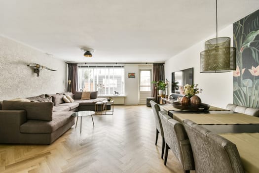 A stylish living room featuring a contemporary sofa, elegant decor, and natural light, creating a cozy yet sophisticated ambiance.