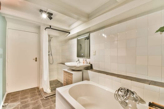 A sleek bathroom featuring clean lines, white tiles, and modern fixtures, creating a bright and refreshing space for relaxation and rejuvenation.