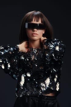 Woman, sunglasses, sequinned top, dark background a stylish woman wearing reflective sunglasses and a sparkling sequinned top stands against a dark background, creating a striking contrast and