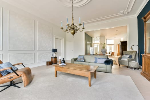 A spacious living room showcasing elegant interior design elements, featuring modern furniture and stylish decor creating a cozy atmosphere.