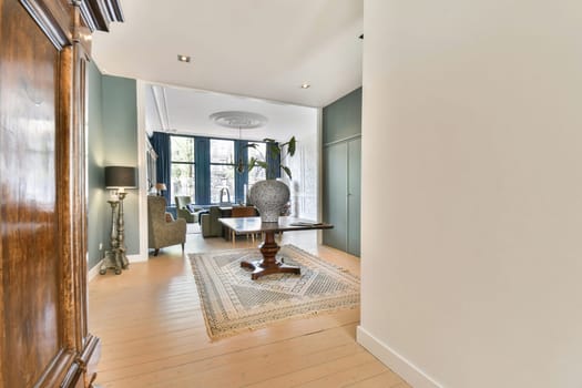 A bright, modern interior showcasing an elegant living space with stylish furniture, wooden flooring, and large windows allowing natural light to flow in.