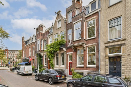 A picturesque street featuring vintage buildings with unique facades, lush greenery, and parked cars, showcasing urban living amidst historical charm.