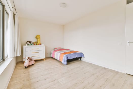 Home interior design of bedroom with bed and wooden wardrobe placed in corner near window in modern apartment