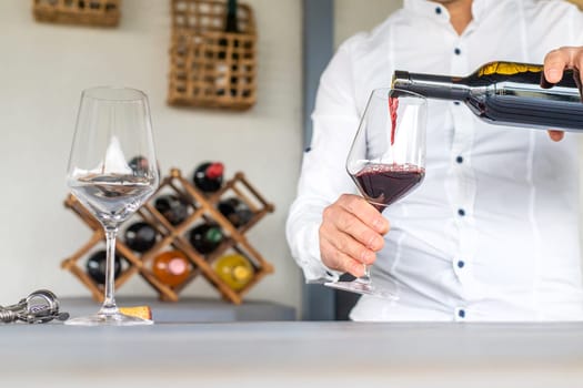 Glass of red wine in hands. Selective focus. drink.