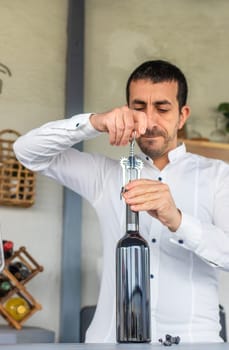 Opening a bottle of wine. Selective focus. drink.