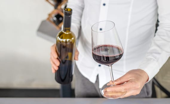 Glass of red wine in hands. Selective focus. drink.