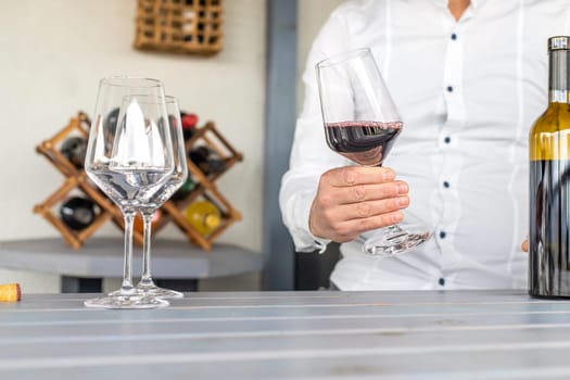 Glass of red wine in hands. Selective focus. drink.