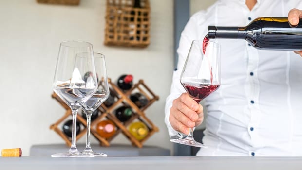 Glass of red wine in hands. Selective focus. drink.