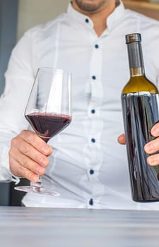 Glass of red wine in hands. Selective focus. drink.