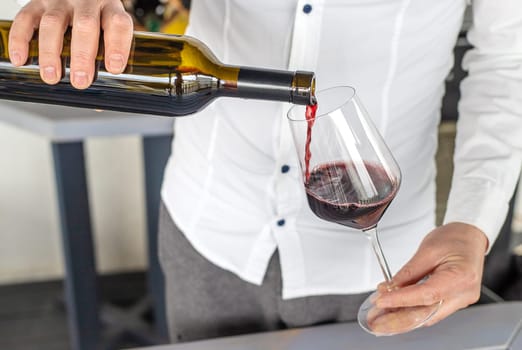 Glass of red wine in hands. Selective focus. drink.