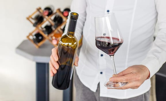 Glass of red wine in hands. Selective focus. drink.