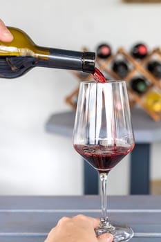 Glass of red wine in hands. Selective focus. drink.
