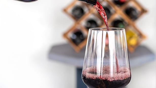 Glass of red wine in hands. Selective focus. drink.