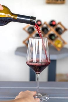 Glass of red wine in hands. Selective focus. drink.