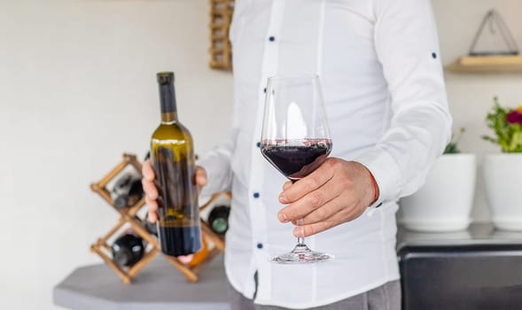Glass of red wine in hands. Selective focus. drink.