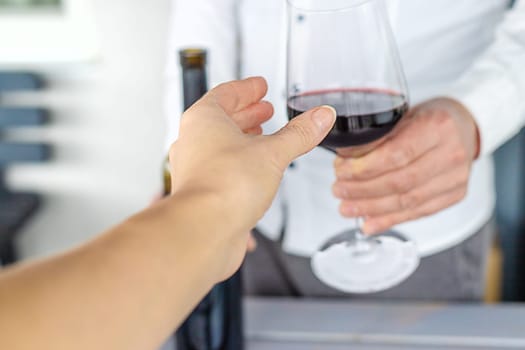 Glass of red wine in hands. Selective focus. drink.
