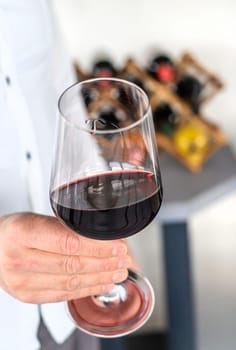 Glass of red wine in hands. Selective focus. drink.