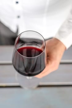 Glass of red wine in hands. Selective focus. drink.