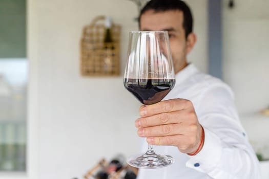 Glass of red wine in hands. Selective focus. drink.