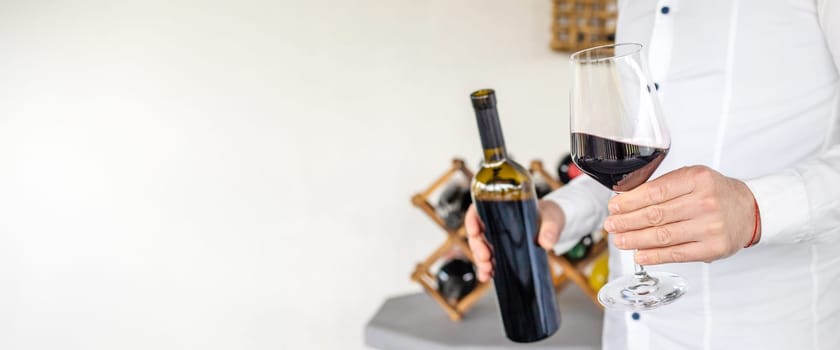 Glass of red wine in hands. Selective focus. drink.