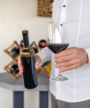 Glass of red wine in hands. Selective focus. drink.