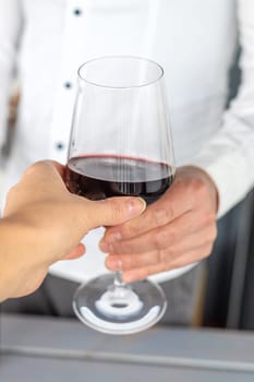 Glass of red wine in hands. Selective focus. drink.