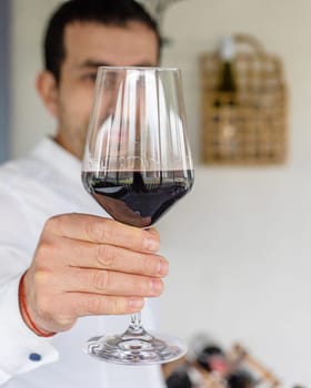 Glass of red wine in hands. Selective focus. drink.
