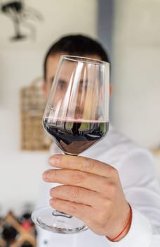 Glass of red wine in hands. Selective focus. drink.