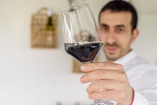 Glass of red wine in hands. Selective focus. drink.