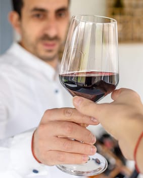 Glass of red wine in hands. Selective focus. drink.