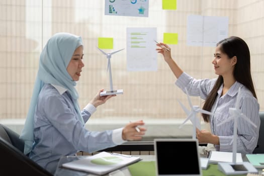 Showcasing their models of wind power, the two professionals discuss data visualization strategies, emphasizing sustainable practices to drive impactful environmental solutions.