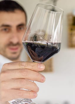 Glass of red wine in hands. Selective focus. drink.