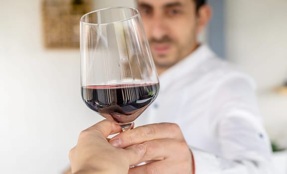 Glass of red wine in hands. Selective focus. drink.
