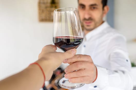 Glass of red wine in hands. Selective focus. drink.