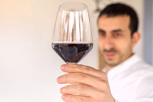Glass of red wine in hands. Selective focus. drink.