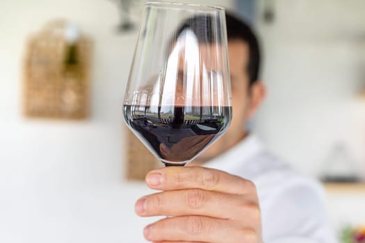 Glass of red wine in hands. Selective focus. drink.