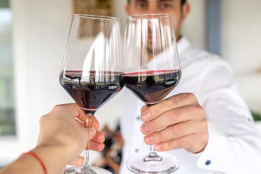 Glass of red wine in hands. Selective focus. drink.