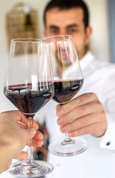 Glass of red wine in hands. Selective focus. drink.