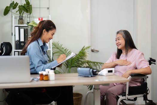 In a tranquil clinic, a nurse takes notes on health updates while engaging with a senior woman, ensuring her comfort and well-being during the medical checkup.
