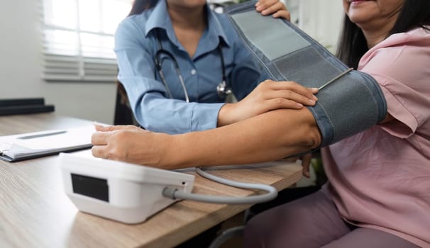 A nursing professional skillfully takes the blood pressure of an elderly patient, ensuring accurate readings and support during the consultation.