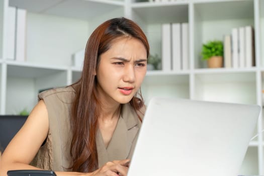 A woman appears concentrated as she evaluates data on her laptop, symbolizing the challenges of staying engaged in task-oriented environments.