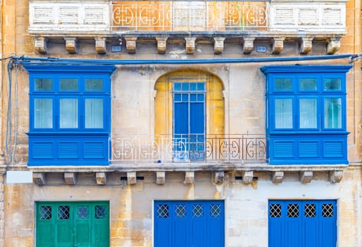 Facade of a residential building with traditional Maltese balconies, Valletta, Malta.